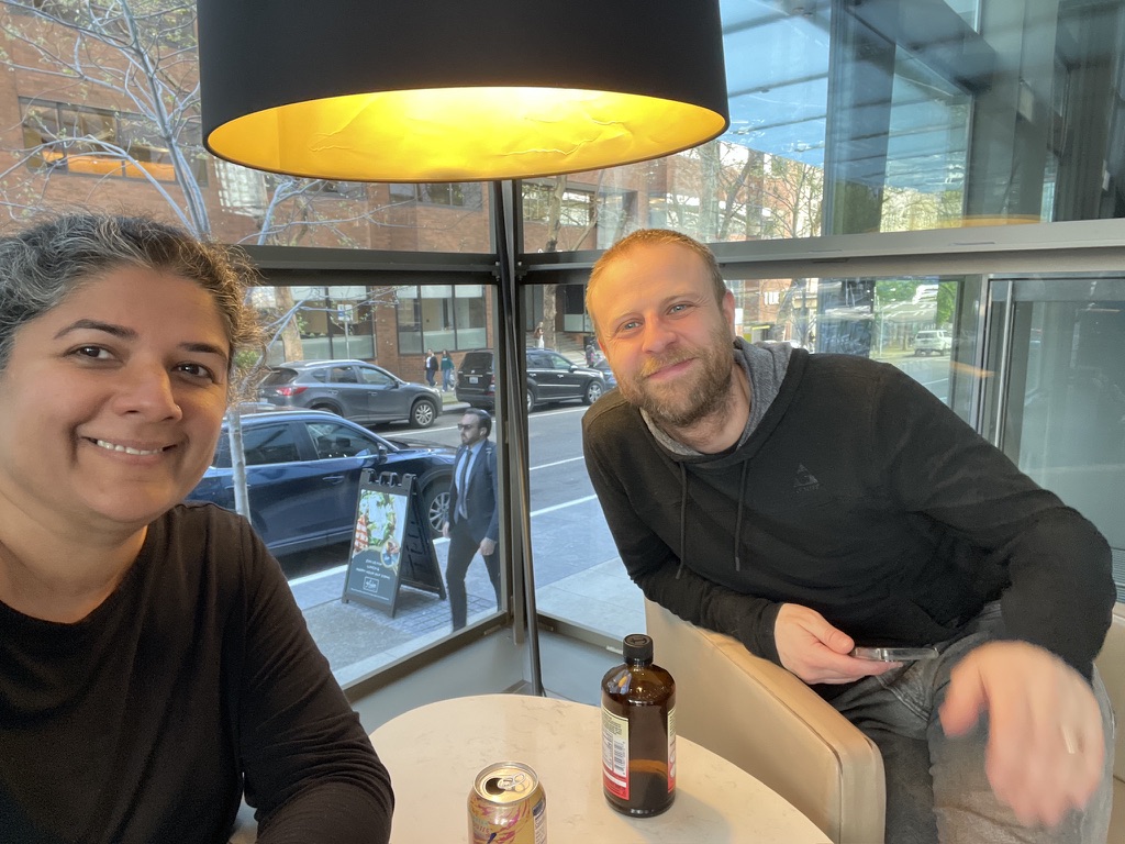 Nandini Deo and Dean Caivano at a café table